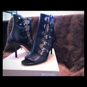 Black leather booties with silver buckles